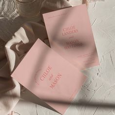 three pink cards sitting on top of each other