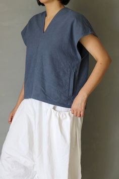 SASAKI-CHIHO(Antique fabric) "Antique linen short sleeves V-neck blouse"  Handmade by Chiho Sasaki Material:Antique linens, from France. Color: Over-dyed,Blue-gray. Size: Neck to cuff : 9.8 inch (25 cm) Chest measurement :41.7 inch(106 cm) Shoulder to hem: 21.2 inch (54 cm) Model:5'2"(157 cm) Thank you Blue Linen V-neck Blouse, Indigo Linen Summer Tops, Summer Linen Tops In Indigo, Summer Indigo Linen Tops, Blue Tops With Natural Dye, Linen Tops With Natural Dye And Short Sleeves, Short Sleeve Linen Tops With Natural Dye, Gray Blouse, Antique Fabrics