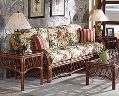 a living room filled with furniture next to a stone wall