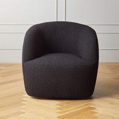 a black chair sitting on top of a wooden floor