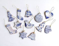 twelve christmas ornaments are arranged on a white surface, including blue and white ceramic ornament