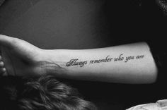 a woman with a tattoo on her arm saying always remember who you are