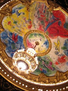 the ceiling is painted with many different colors and designs, as well as gold trimmings