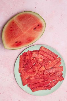 slices of watermelon on a plate next to a cut up piece of watermelon