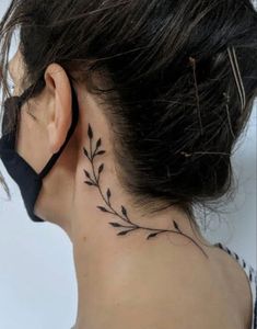 the back of a woman's neck has a tattoo on it