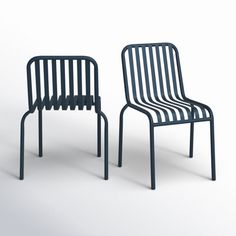 two black chairs sitting next to each other on a white surface and one chair is made out of metal