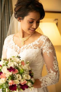 a woman in a wedding dress holding a bouquet