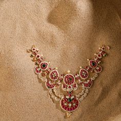 Description: Inspired by the opulence of Indian heritage, this regal floral Jadau set choker is a bridal trousseau essential. Semi-precious Polki and kempu stones, cascade down to a chaand motif. Tiny pearls outlined all the motifs making it a proud testimony to the mastery of artisans. This silver necklace is part of the Vihara family, designed by our Paksha senior designer. Product Information Materials used : 925 Silver with 1.0-microns Antique Gold Plating Stones: Semi precious stones Length Elegant Bridal Sets With Tilla For Traditional Ceremonies, Elegant Bridal Sets For Traditional Ceremonies, Elegant Kundan Jewelry For Traditional Ceremonies, Elegant Kundan Bridal Sets For Traditional Ceremonies, Temple Jewelry Bridal Necklace With Intricate Design For Reception, Temple Style Bridal Necklace With Intricate Design For Reception, Traditional Ruby Bridal Necklace For Festive Occasions, Traditional Ruby Bridal Necklace For Festive Season, Festive Ruby Necklace For Reception