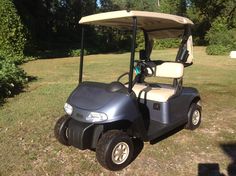 a golf cart is parked in the grass