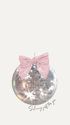 a silver disco ball with a pink bow on it