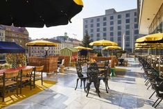 an outdoor dining area with tables and umbrellas