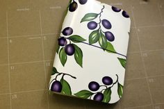 the wrapping paper is decorated with an image of plums