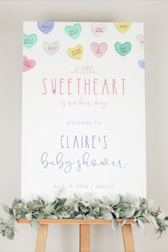 a welcome sign for a baby shower with hearts on it