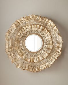 a round mirror hanging on the wall