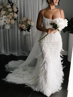 a woman in a wedding dress holding a bouquet