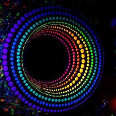 an image of a colorful circular design in the dark