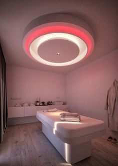 a large white bath tub sitting under a circular light