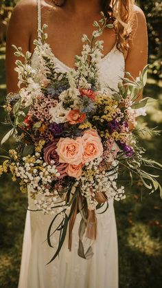 a woman holding a bouquet of flowers in her hands