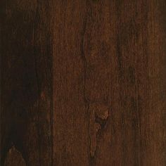 a close up view of a wood floor with dark brown stain on the top and bottom