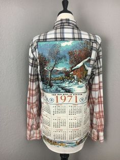 the back of a plaid shirt with a painting on it's chest and sleeves