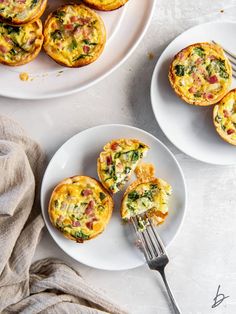 two plates with mini quiches on them next to a fork