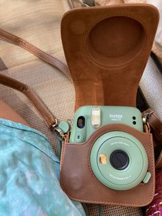 an instax camera sitting on top of a bag