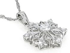 Moissanite Fire® .56ctw diamond equivalent weight round brilliant, Platineve® snowflake pendant and 18 inch Singapore chain. Measures approximately 1" L x 5/8" W. Chain has a lobster clasp and two inch extender. Actual moissanite weight is .53ctw. Diamond White Snowflake Jewelry For Formal Occasions, Formal Snowflake Diamond White Jewelry, Diamond White Snowflake Jewelry For Anniversary, Formal Diamond Snowflake Jewelry, Formal Snowflake Diamond Jewelry, White Gold Diamond Snowflake Jewelry, Fun Clothes, Snowflake Pendant, Round Brilliant