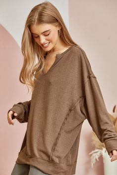 Easy hacci tunic top with split neckline and raw edge details all over this tunic top. We love the banded hemline and sleeves. Slight oversized fit with stretchy material. Also super soft. 95% Polyester, 5% Spandex Worth The Wait, Raw Edge, Tunic Top, Stretchy Material, Oversized Fits, Mocha, Tunic Tops, Split, Spandex