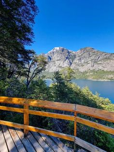 a wooden deck overlooks a mountain lake