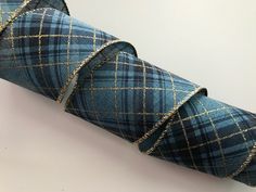 a roll of blue and gold plaid fabric