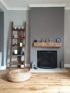 a living room with a fire place and shelves