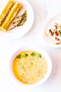 three bowls filled with different types of food on top of a white tablecloth next to corn