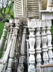 an old wooden fence is leaning against the side of a house with many pieces of wood sticking out of it