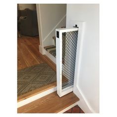 a dog door is open on the floor next to a stair case in a house