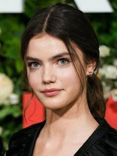 a close up of a person wearing a black dress