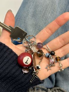 keyring inspo . keychain inspo . 7 ball keyring . maximalist keyring inspo . keyring aesthetic Cute Keyring Aesthetic, Key Charms Aesthetic, The Black Keys Aesthetic, Vintage Keychain Aesthetic, Key Rings Aesthetic, Outfit Inspo Accessories, Keychain Charms Aesthetic, Aesthetic Keys With Keychain, Diy Car Keychain Ideas