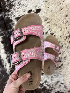 Add a pop of playful flair to your summer wardrobe with these Pink and White Blossom Glimmer Hand-Tooled Sandals. The vibrant pink magenta hue will make a statement while the supple leather and comfort sole ensure all-day comfort. Perfect for market strolls or poolside lounging, these sandals add personality to any outfit. Trendy Pink Slip-on Sandals, Pink Slip-on Summer Sandals, Pink Slip-on Sandals For Summer, Spring Sandals With Buckle Closure For Outings, Pink Summer Sandals With Cushioned Footbed, Trendy Pink Sandals With Buckle Closure, Pink Sandals With Cushioned Footbed For Vacation, Pink Cushioned Sandals For Vacation, Pink Cushioned Summer Sandals