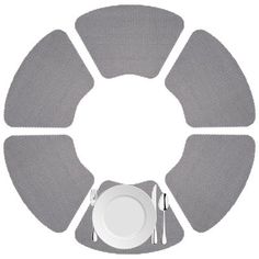 a plate, fork and knife on top of a white plate with grey circles around it