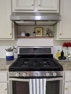 an oven with a towel hanging from it's front and side shelves above it