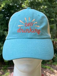 Get your day drinking on pool side, beach side or just on the porch! Can be made on any hat in out store, in any color combination! Specs: 55/45 cotton/polyester Unstructured, six-panel, low-profile Pre-curved visor Plastic tab closure All hand-crafted with a special dye and washing process which results in unique variations of color from one hat to the next. Special consideration must also be taken when printing white ink on pigment-dyed cotton Cotton Trucker Hat For The Beach, Fun Blue Trucker Hat For Vacation, Fun Blue Hats For Beach Season, Blue Fun Hat For Beach Season, Fun Blue Hat For Beach Season, Fun Trucker Hat For Beach Season, Vacation Brimmed Trucker Hat One Size, Vacation Brimmed Trucker Hat, Fun Visor Trucker Hat For The Beach