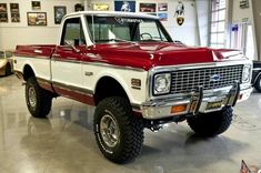 a red and white truck parked in a garage