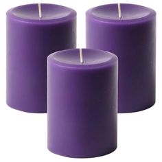 three purple candles sitting next to each other