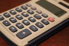 a calculator sitting on top of a wooden table