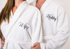 a man and woman in white robes with their arms around each other