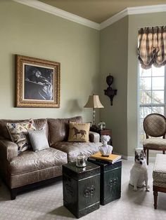 a living room filled with furniture and a dog sitting on the floor next to it