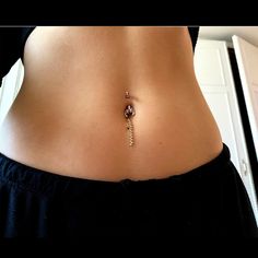 a woman's stomach with a beaded belly ring on the bottom and side