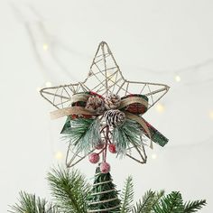 a star ornament hanging from a christmas tree