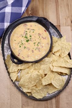 a bowl of soup and chips on a plate