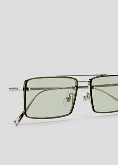 Lightweight layered stainless steel frame with rectangular lenses. Adjustable nose pads. Silver metal frames with olive lenses. Silver Sunglasses With Mirrored Lenses In Polycarbonate, Adjustable Square Frame Tinted Sunglasses, Modern Blue Polycarbonate Sunglasses, Gray Tinted Polycarbonate Sunglasses, Gray Tinted Glass Sunglasses, Stainless Steel Frame, Steel Frame, Metal Frame, Sale Items