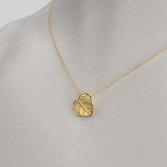 Capture nature's beauty with our dainty Italian 14k or 18k gold heart pendant and chain. Exquisitely small and adorned with a delicate leaf motif, this pendant is a wearable piece of art that symbolizes love and connection. Meticulously crafted in Italy, the intricate details and fine craftsmanship make this tiny heart pendant a cherished expression of elegance and nature's grace. 14k or 18k gold 16mm high 15mm large 18k Rolò chain chain length 45cm chain thickness 1.5mm designed and crafted in Italy Small Heart Pendant, Gold Heart Pendant, Leaf Motif, Heart Pendant Gold, Italian Jewelry, Gold Heart Necklace, Tiny Heart, Rolo Chain, Small Heart